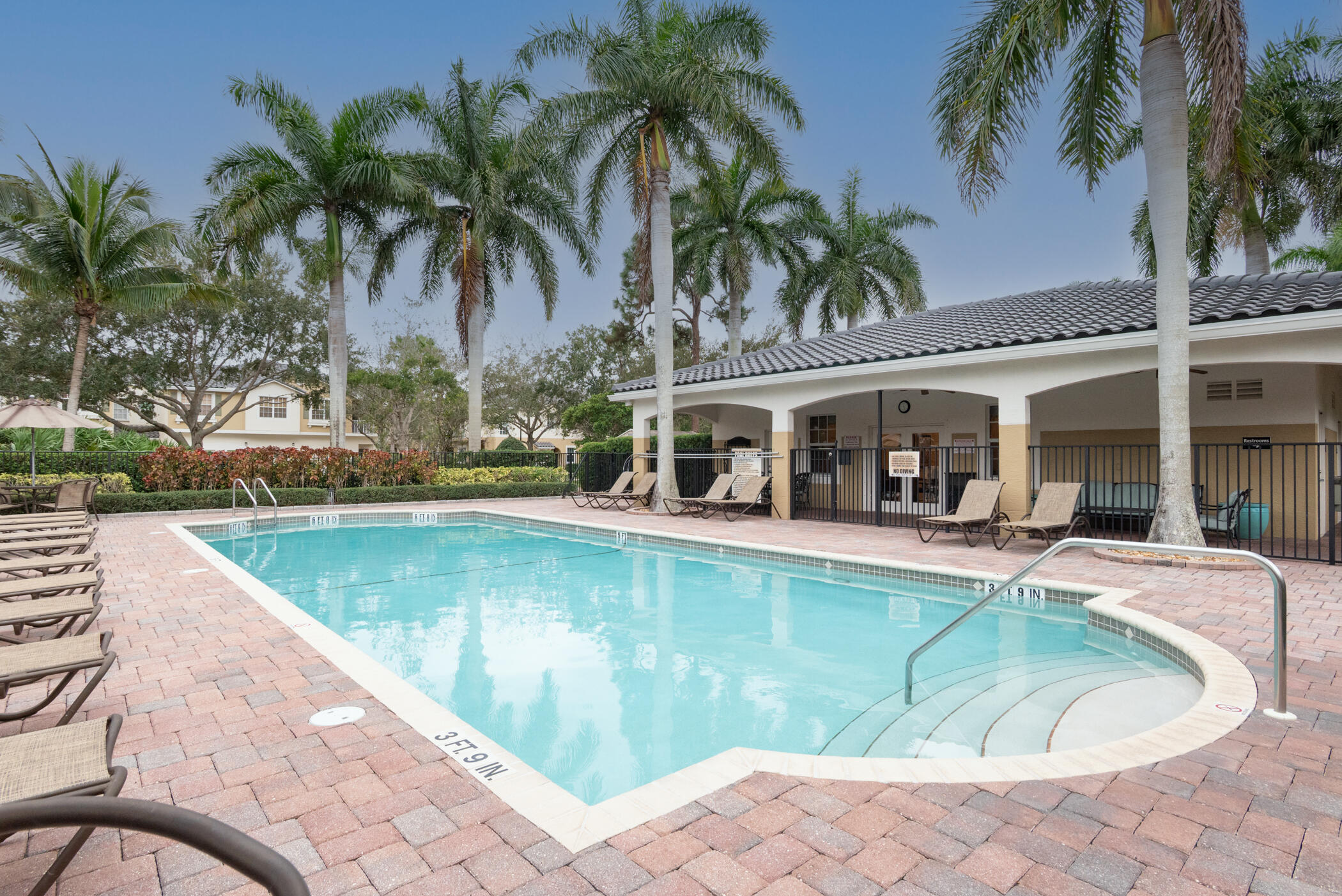 1600 Southeast Sheffield Terrace, Unit 201 Stuart, FL 34994 - Photo 25 of 28 a view of a swimming pool with chair and tables