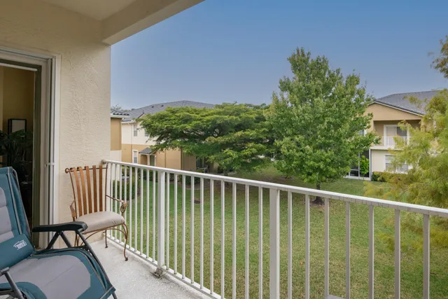 a view of a balcony with chair and wooden fence