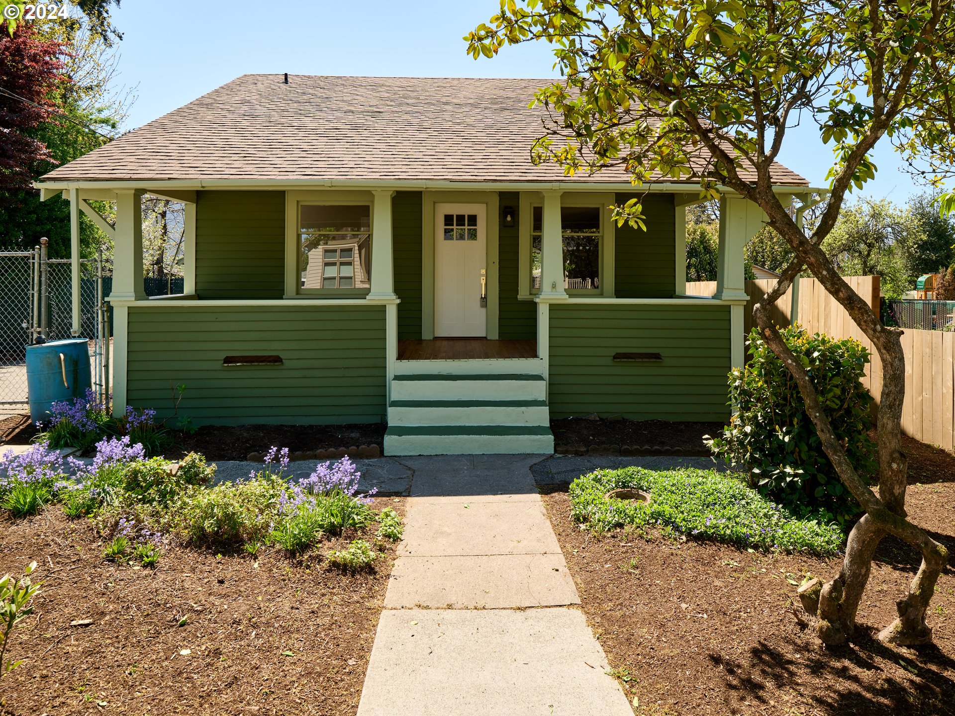 a front view of a house with a garden