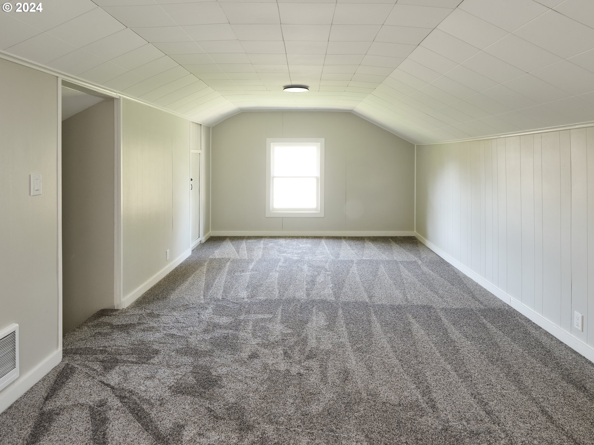 10342 Southeast Ramona Street Portland, OR 97266 - Photo 14 of 17 an empty room with windows and entrance