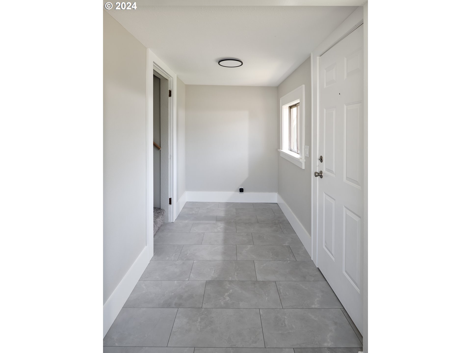 10342 Southeast Ramona Street Portland, OR 97266 - Photo 16 of 17 a view of a hallway with wooden floor