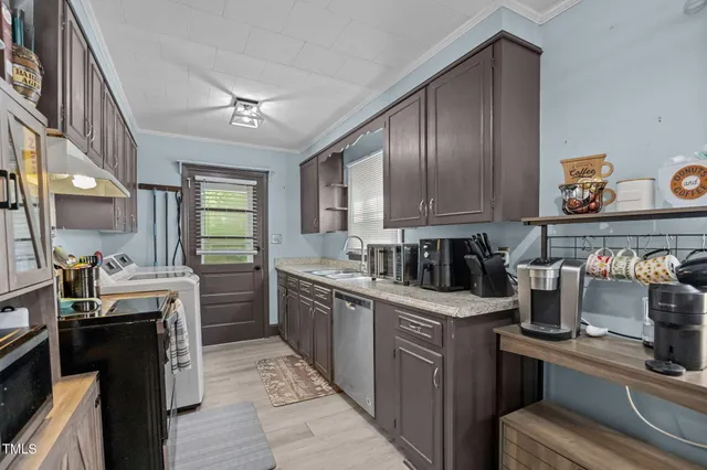 a kitchen with cabinets and window