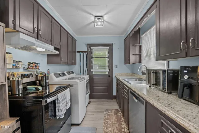 a kitchen with stainless steel appliances granite countertop a stove a sink dishwasher and a refrigerator