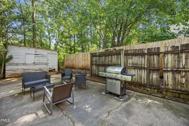 a view of a patio with a table and chairs