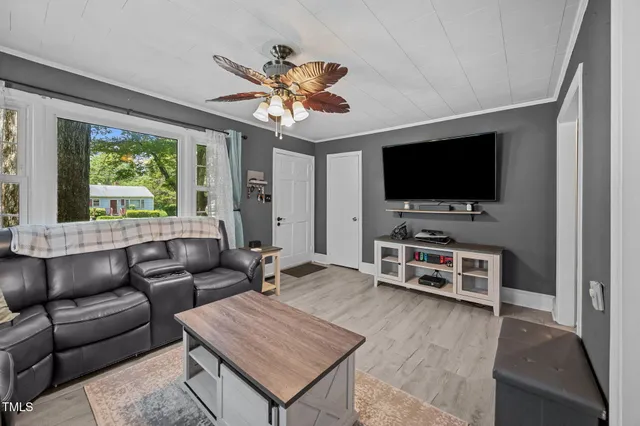 a living room with furniture and a flat screen tv
