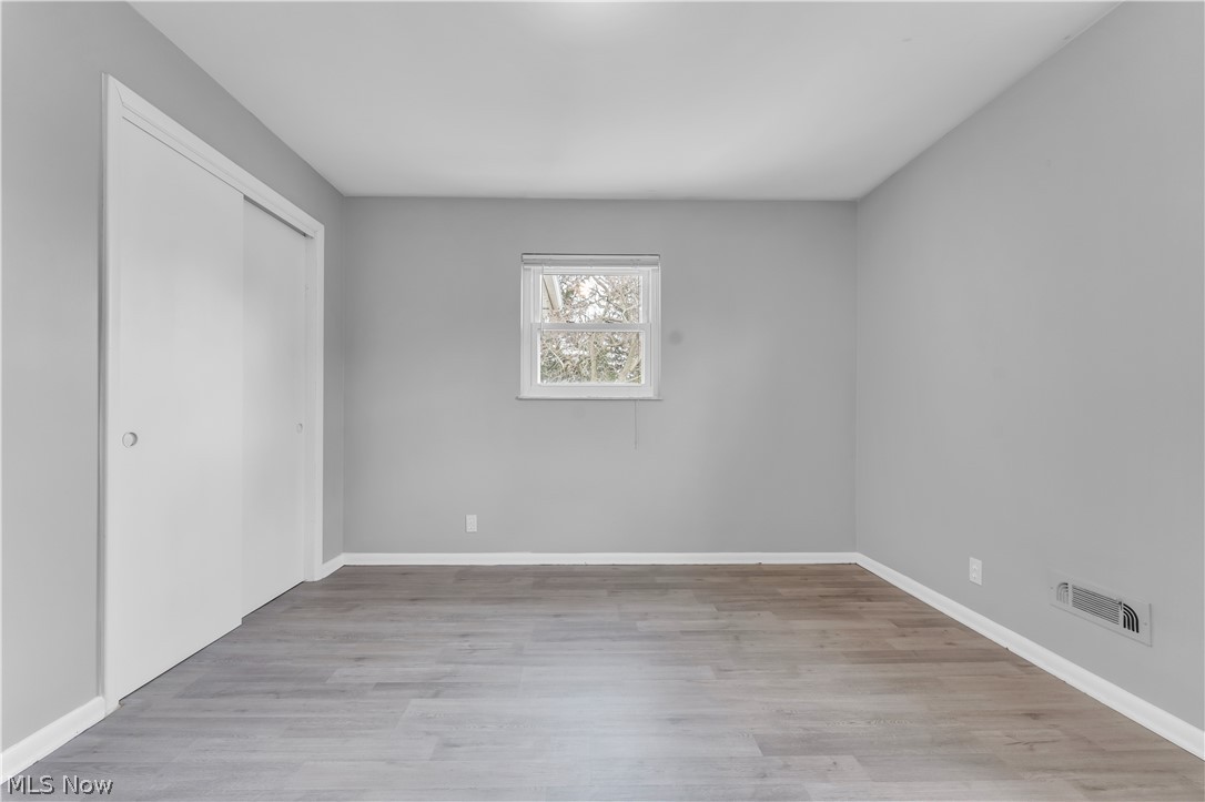 2915 Snow Road, Unit 2/UP Cleveland, OH 44134 - Photo 11 of 23 Neutral-toned room featuring light wood-finish flooring and a white trimmed window