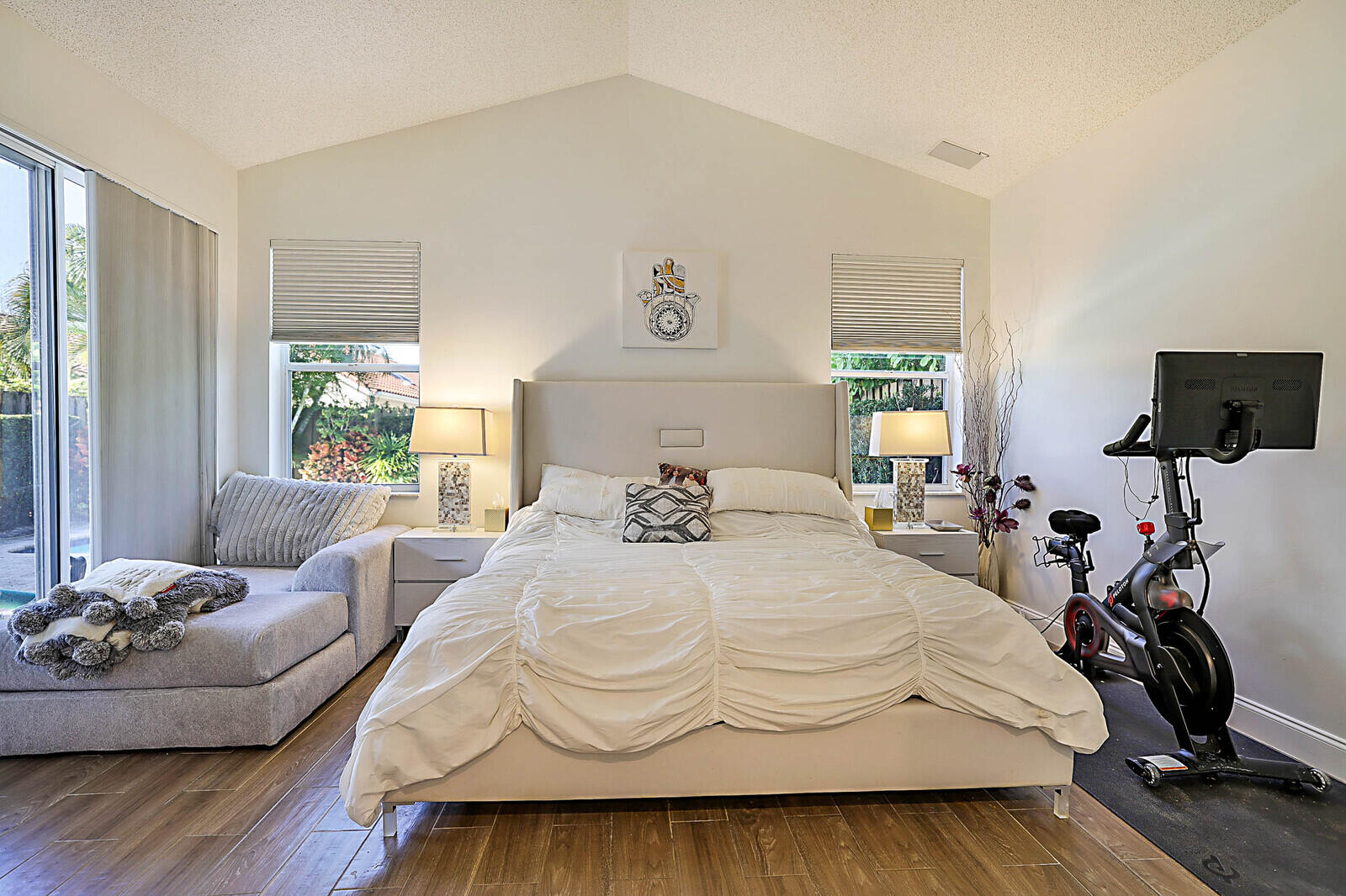 6655 Northwest 25th Avenue Boca Raton, FL 33496 - Photo 19 of 33 a bedroom with a bed and wooden floor