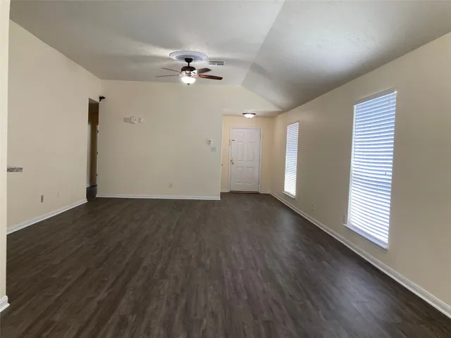 wooden floor in an empty room with a window