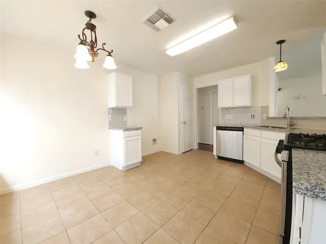 a kitchen with a sink cabinets and window