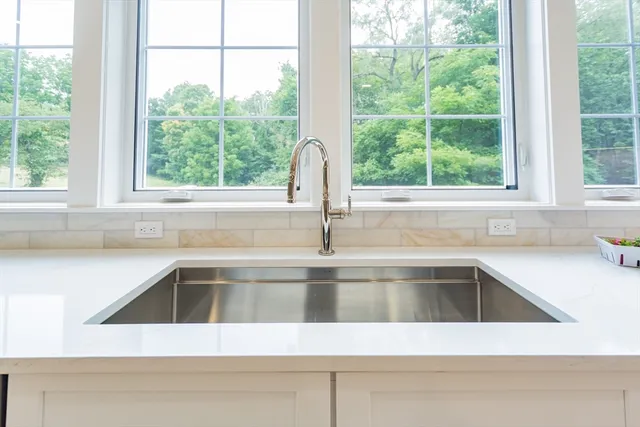 a view fireplace with a sink and mirror