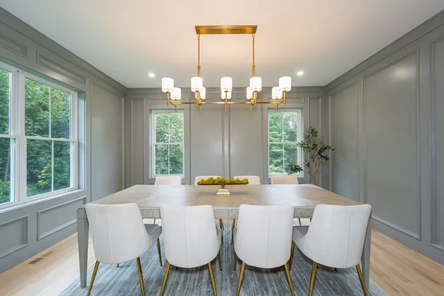 a view of a dining room with furniture wooden floor and chandelier