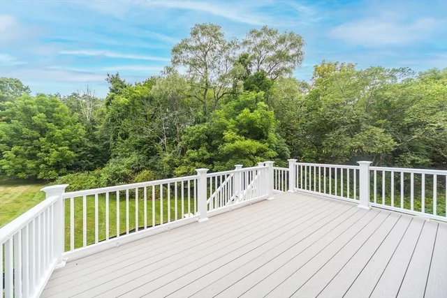 a balcony with wooden floor and fence