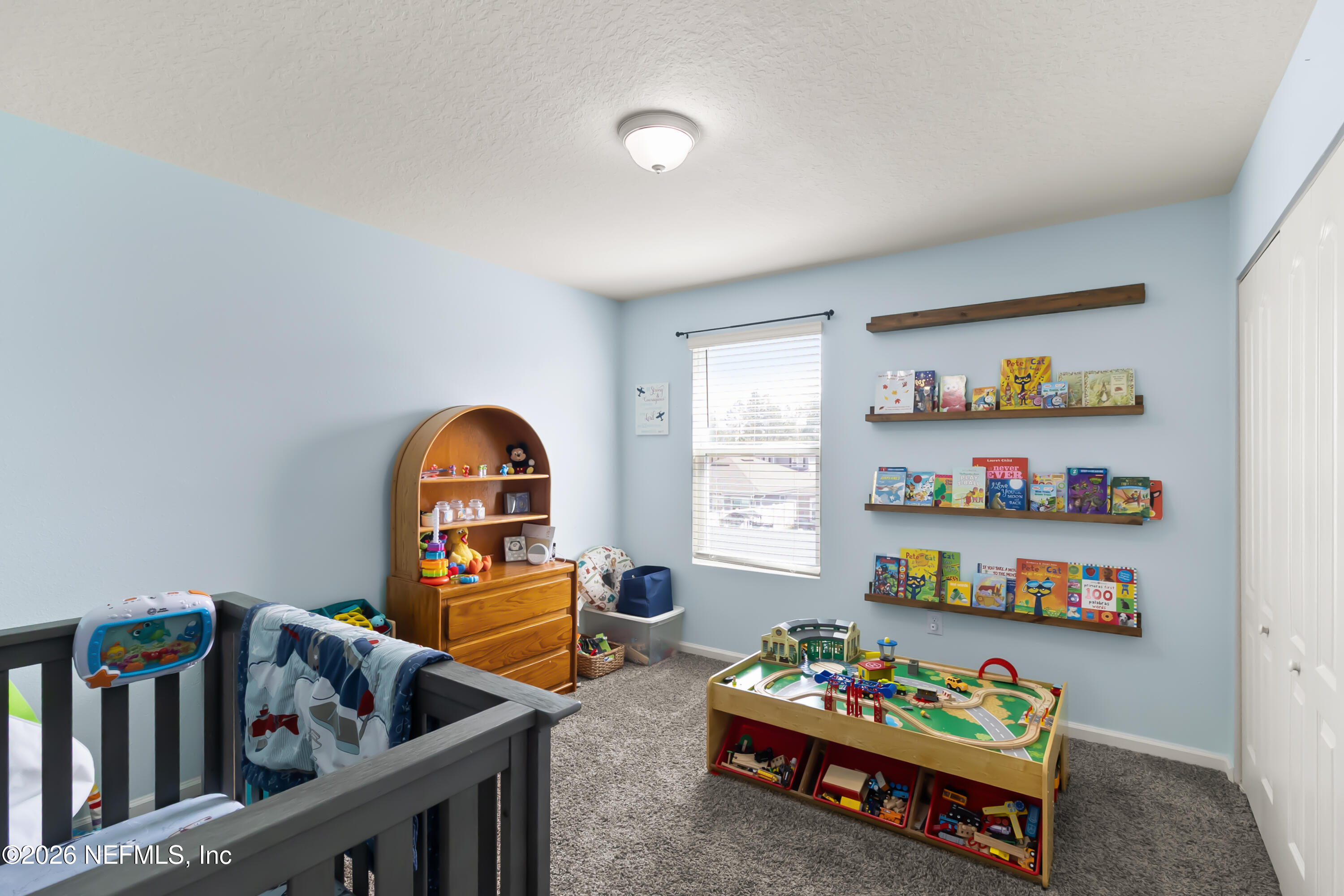 3825 Bronco Road Middleburg, FL 32068 - Photo 11 of 18 a living room with baby crib furniture and a window