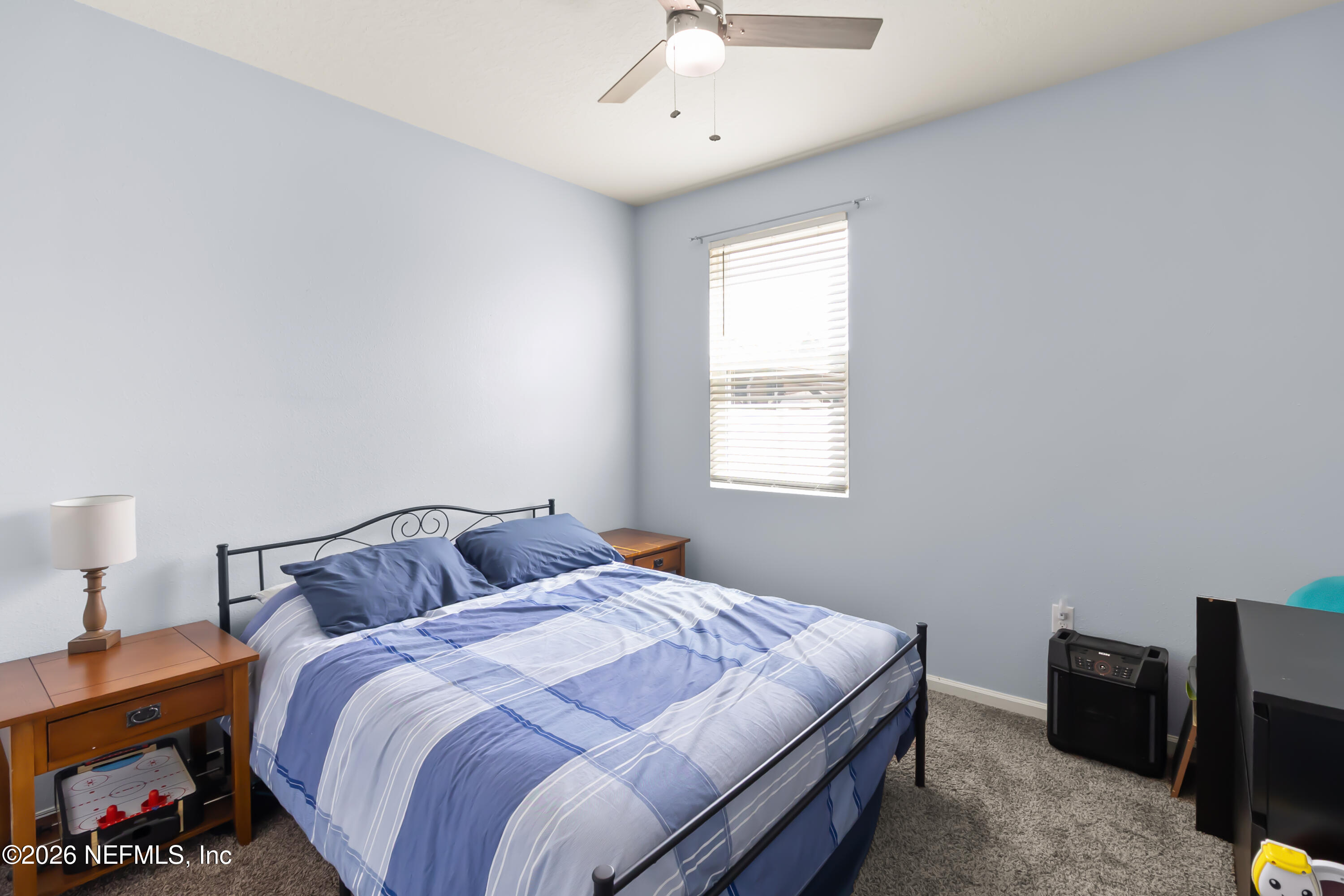 3825 Bronco Road Middleburg, FL 32068 - Photo 12 of 18 a bedroom with a bed and wooden floor