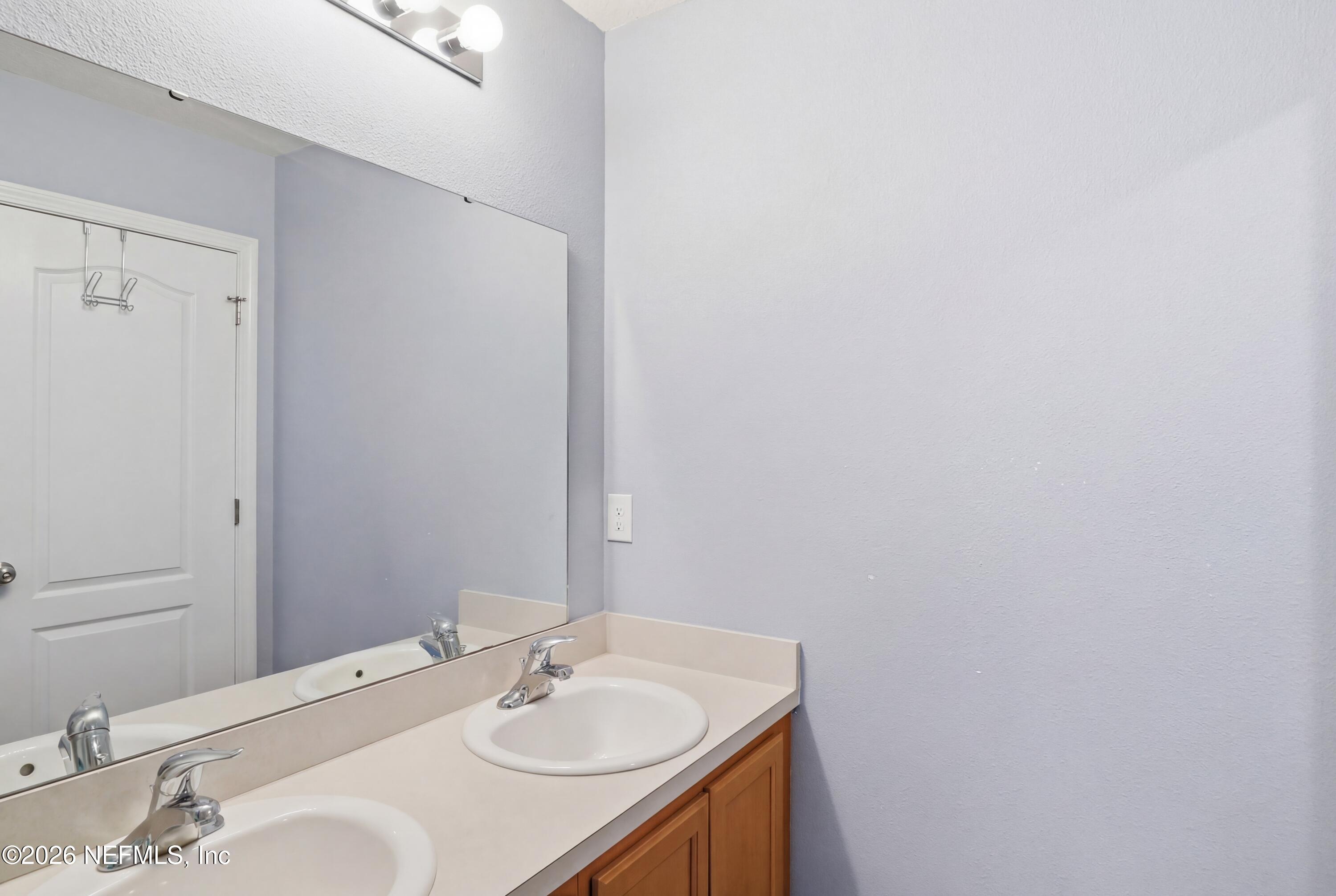 3825 Bronco Road Middleburg, FL 32068 - Photo 15 of 18 a bathroom with a sink vanity and a mirror