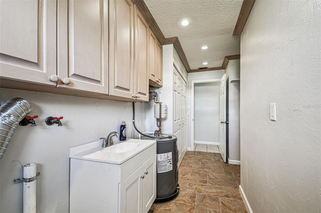 529 Johns Pass Avenue Madeira Beach, FL 33708 - Photo 23 of 100 a bathroom with a sink and a washing machine