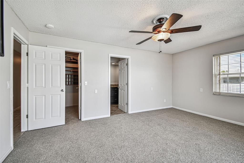 529 Johns Pass Avenue Madeira Beach, FL 33708 - Photo 25 of 100 an empty room with windows and fan