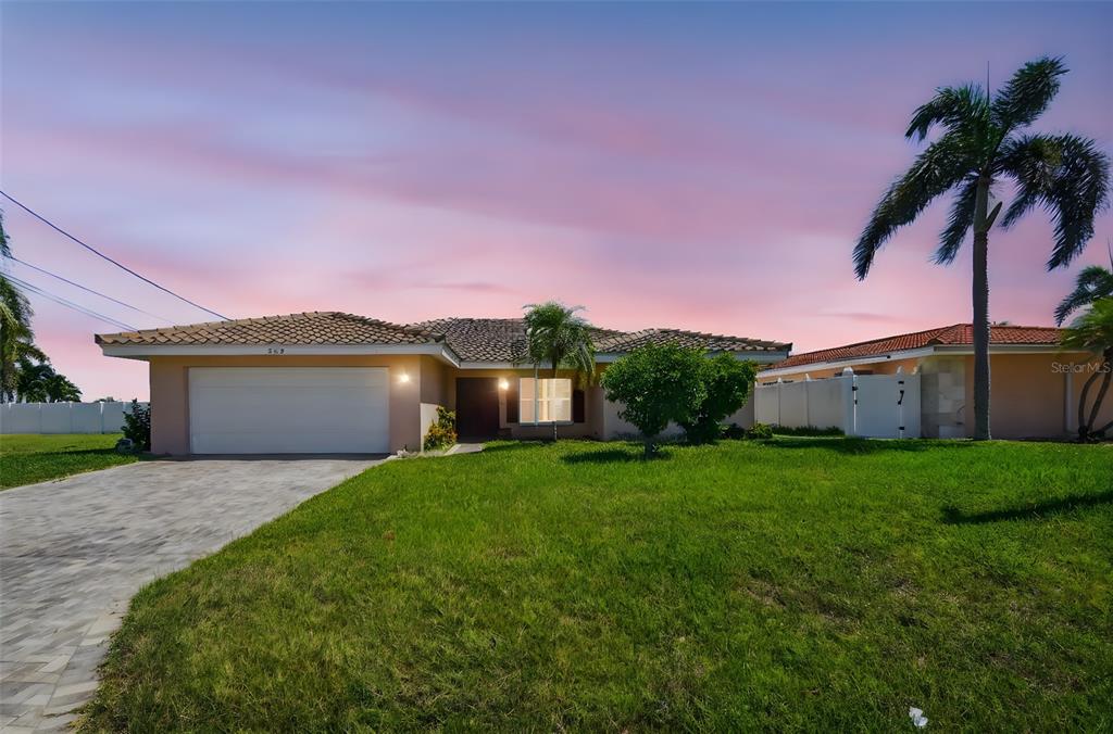 529 Johns Pass Avenue Madeira Beach, FL 33708 - Photo 3 of 100 a front view of a house with a yard and garage