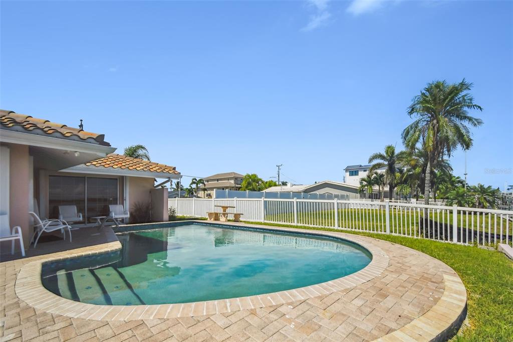 529 Johns Pass Avenue Madeira Beach, FL 33708 - Photo 36 of 100 a view of a swimming pool with a garden