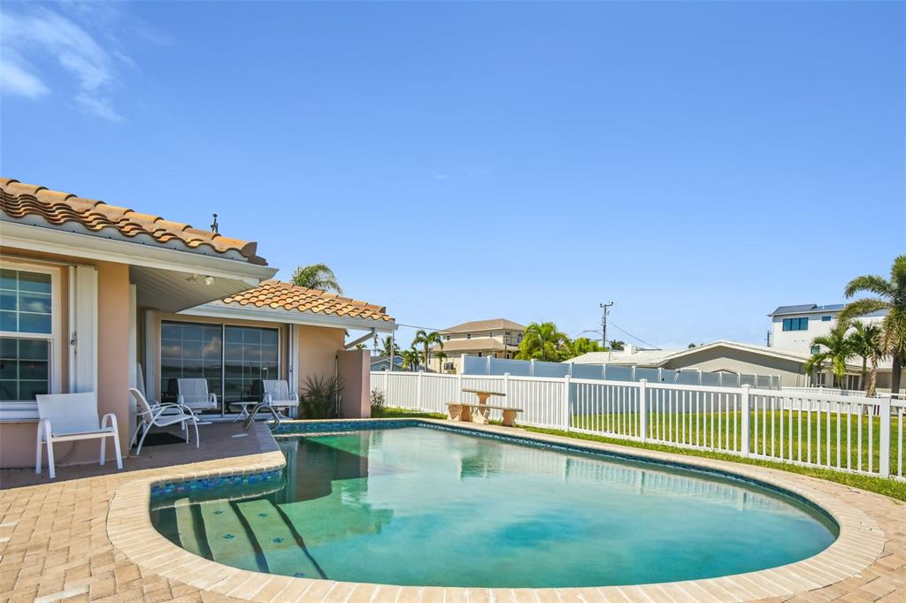 529 Johns Pass Avenue Madeira Beach, FL 33708 - Photo 37 of 100 a view of a swimming pool with a patio