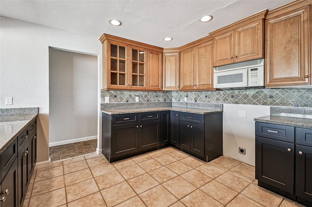 529 Johns Pass Avenue Madeira Beach, FL 33708 - Photo 40 of 100 a kitchen with stainless steel appliances granite countertop a stove and a refrigerator