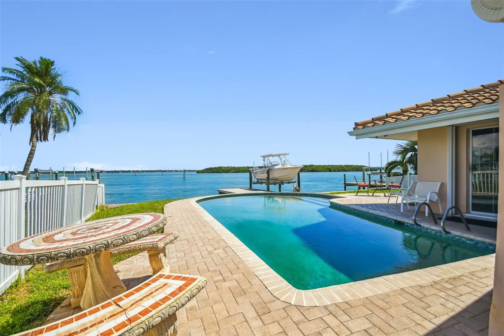 529 Johns Pass Avenue Madeira Beach, FL 33708 - Photo 4 of 100 a view of a swimming pool with an outdoor seating