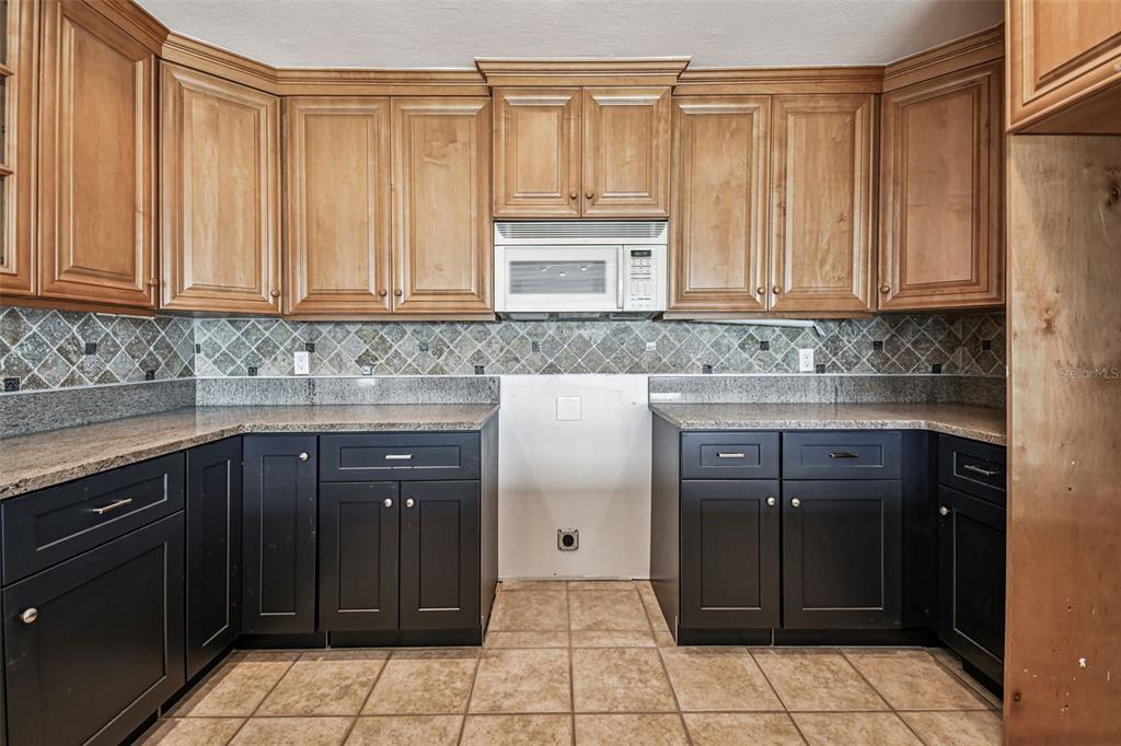 529 Johns Pass Avenue Madeira Beach, FL 33708 - Photo 42 of 100 a kitchen with a cabinets and counter space