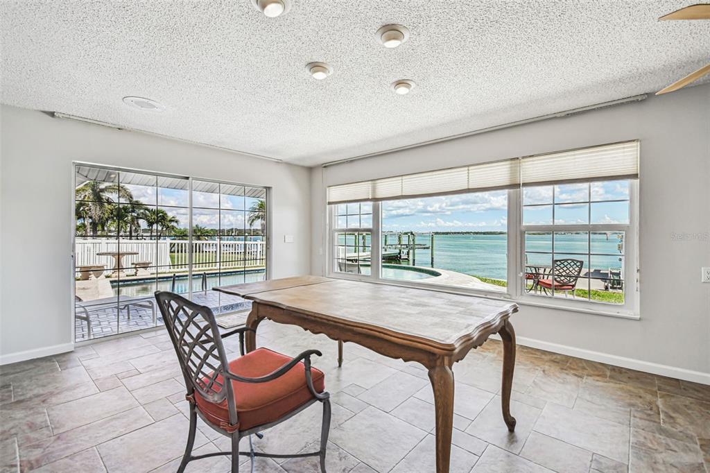 529 Johns Pass Avenue Madeira Beach, FL 33708 - Photo 49 of 100 a dining room with a table and chairs