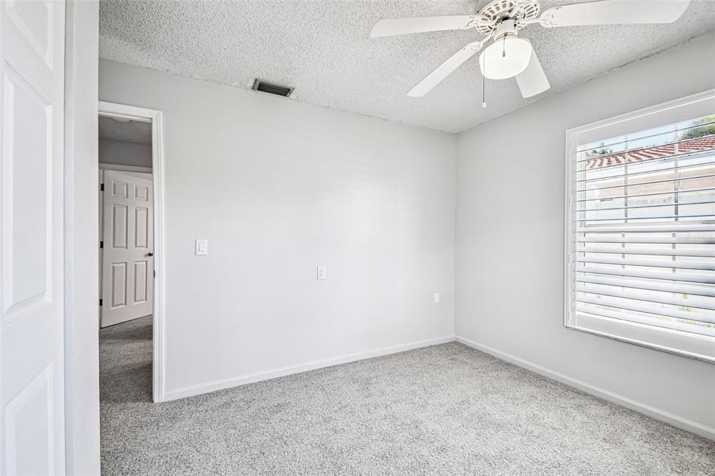 529 Johns Pass Avenue Madeira Beach, FL 33708 - Photo 64 of 100 an empty room with a window and a chandelier fan