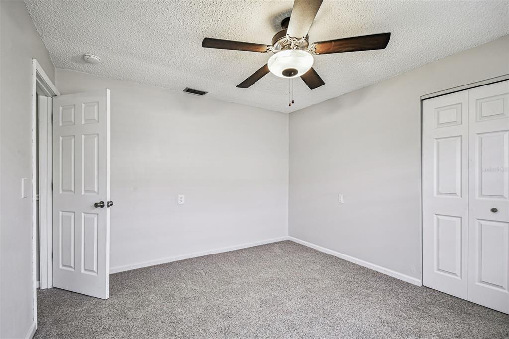 529 Johns Pass Avenue Madeira Beach, FL 33708 - Photo 71 of 100 an empty room with a ceiling fan and fan