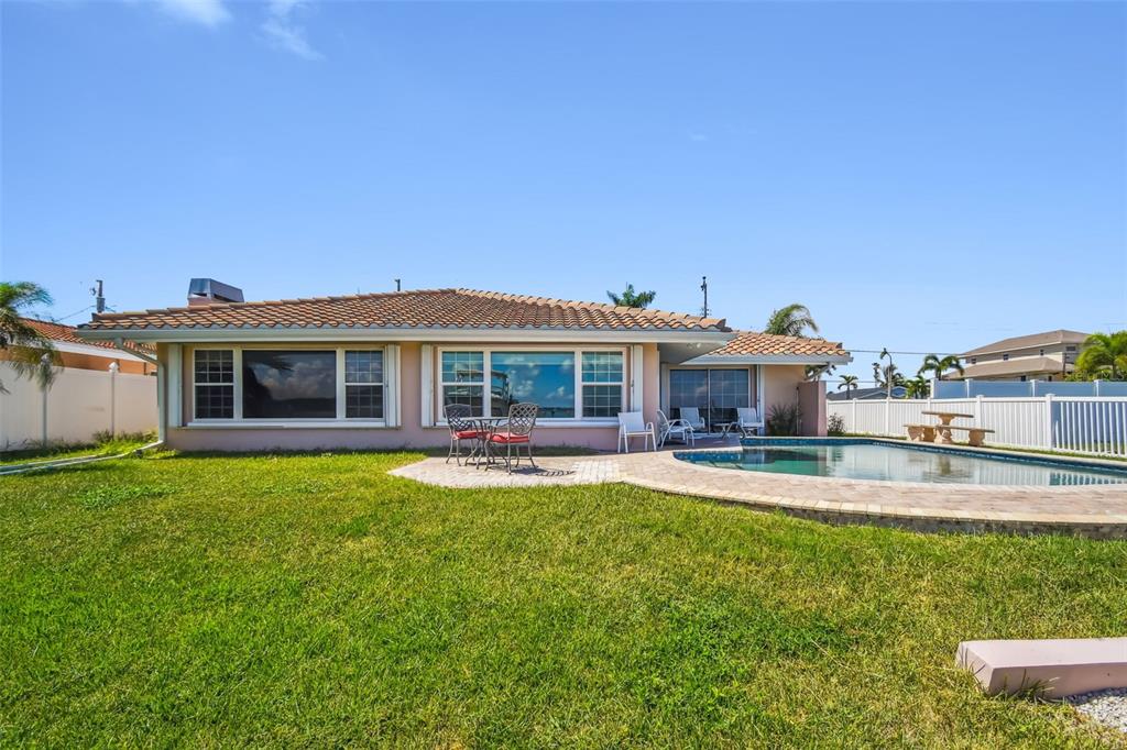 529 Johns Pass Avenue Madeira Beach, FL 33708 - Photo 76 of 100 a view of a house with a yard and sitting area