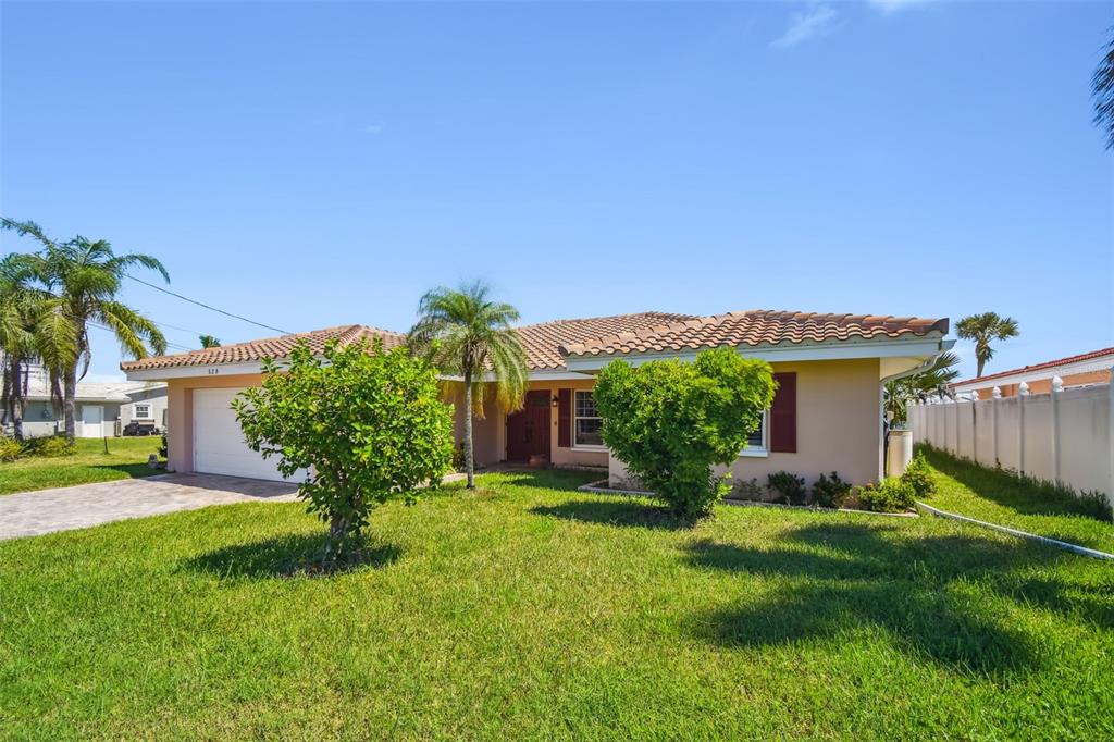 529 Johns Pass Avenue Madeira Beach, FL 33708 - Photo 8 of 100 a view of a house with a yard and table in front of it