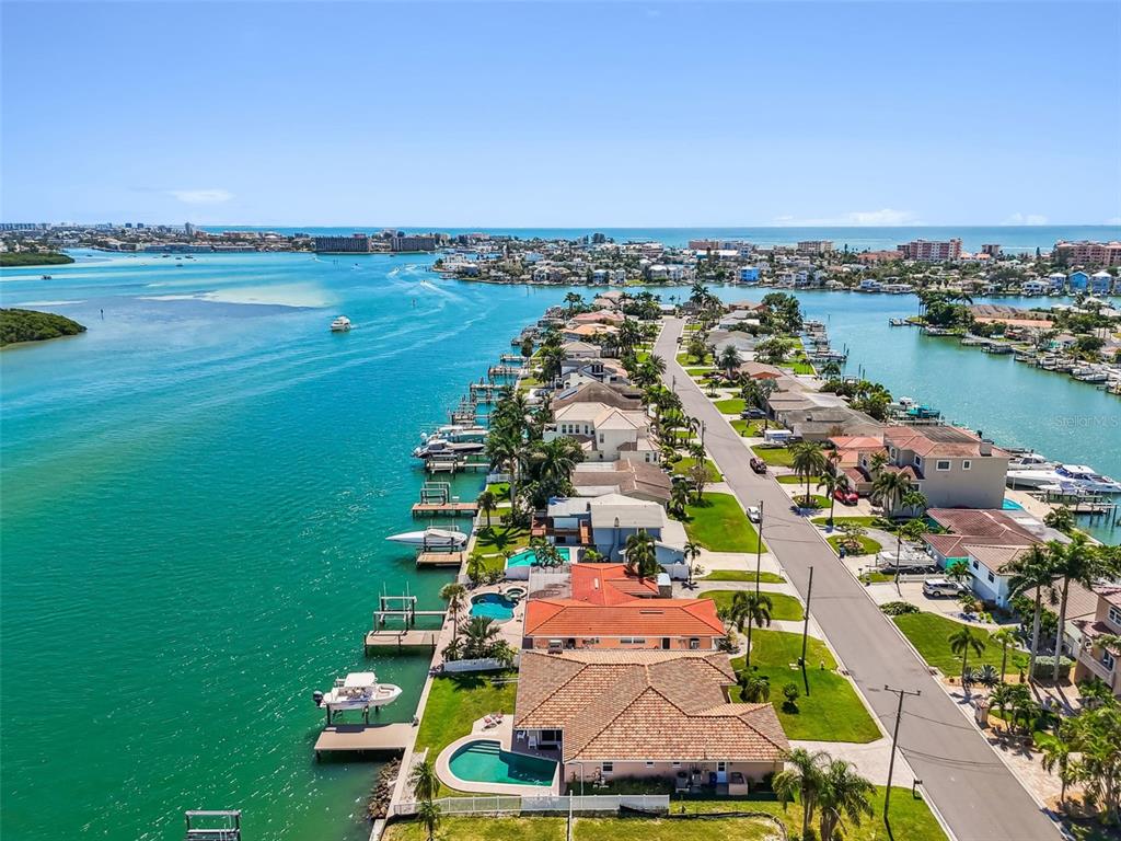 529 Johns Pass Avenue Madeira Beach, FL 33708 - Photo 87 of 100 an aerial view of a city with lots of residential buildings ocean and mountain view in back