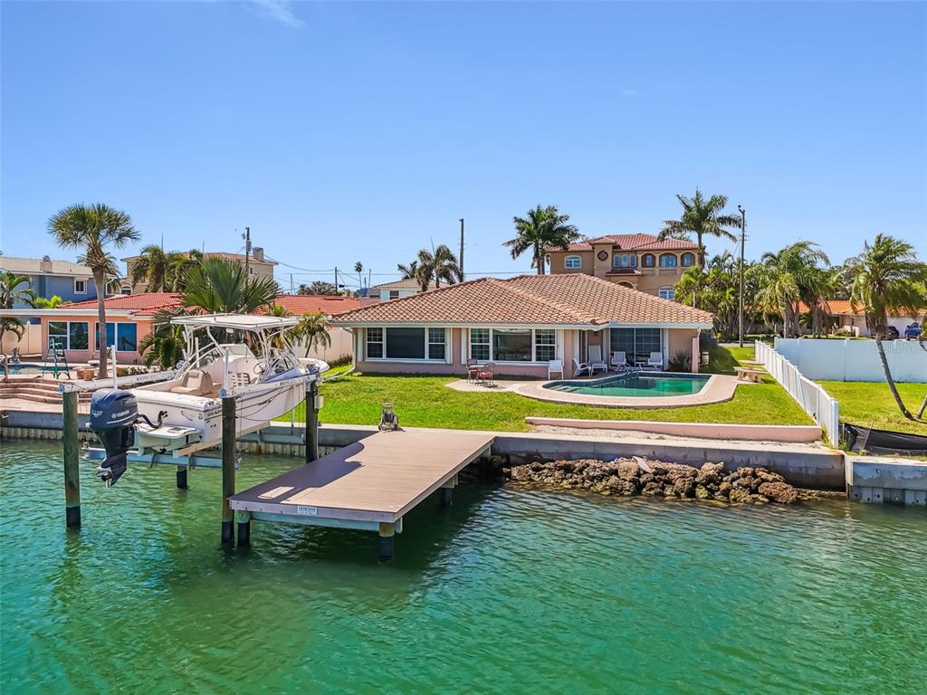 529 Johns Pass Avenue Madeira Beach, FL 33708 - Photo 88 of 100 a aerial view of a house with swimming pool garden view and a lake view