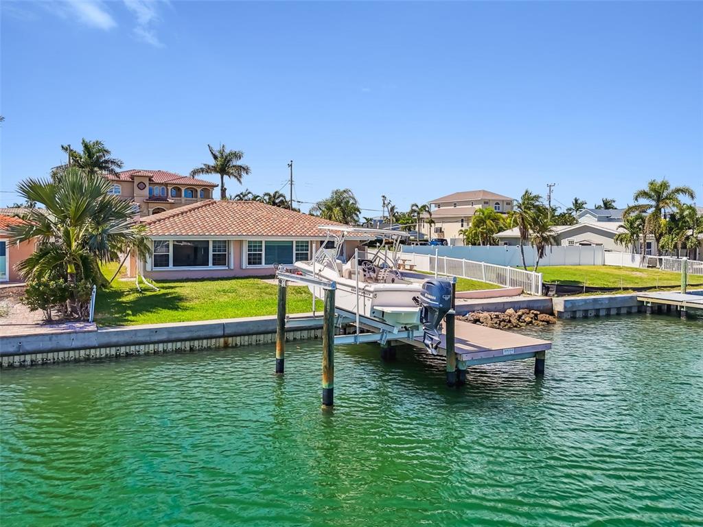 529 Johns Pass Avenue Madeira Beach, FL 33708 - Photo 90 of 100 a view of a swimming pool with lawn chairs under an umbrella