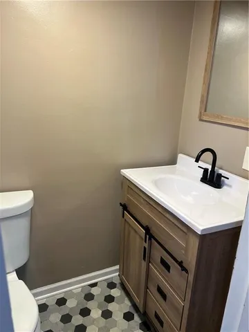 a bathroom with a sink a toilet a sink and vanity