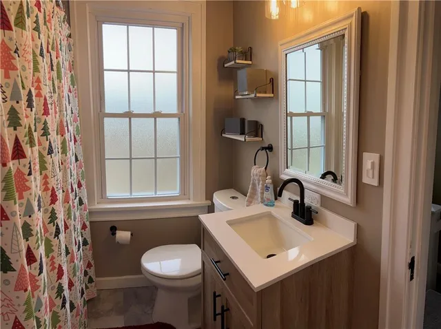 a bathroom with a sink toilet and mirror