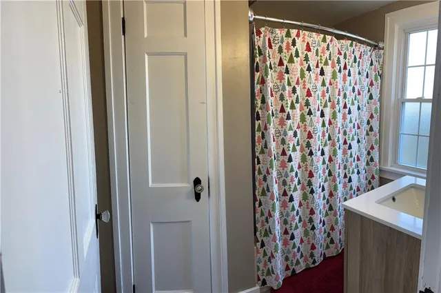 a bathroom with a shower curtain and a curtain