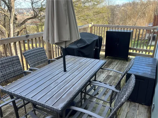 a view of a deck with wooden floor and outdoor seating