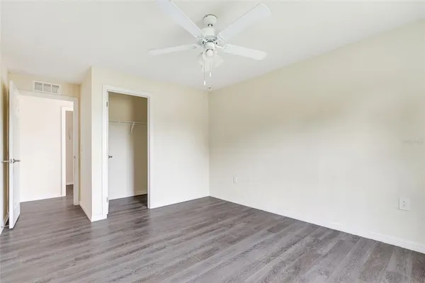 a view of an empty room with wooden floor