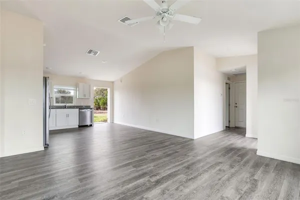a view of a kitchen with a sink and a window