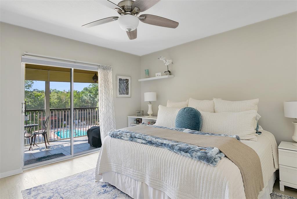 259 South Cypress Road, Unit 546 Pompano Beach, FL 33060 - Photo 12 of 23 a bedroom with a large bed and a large window