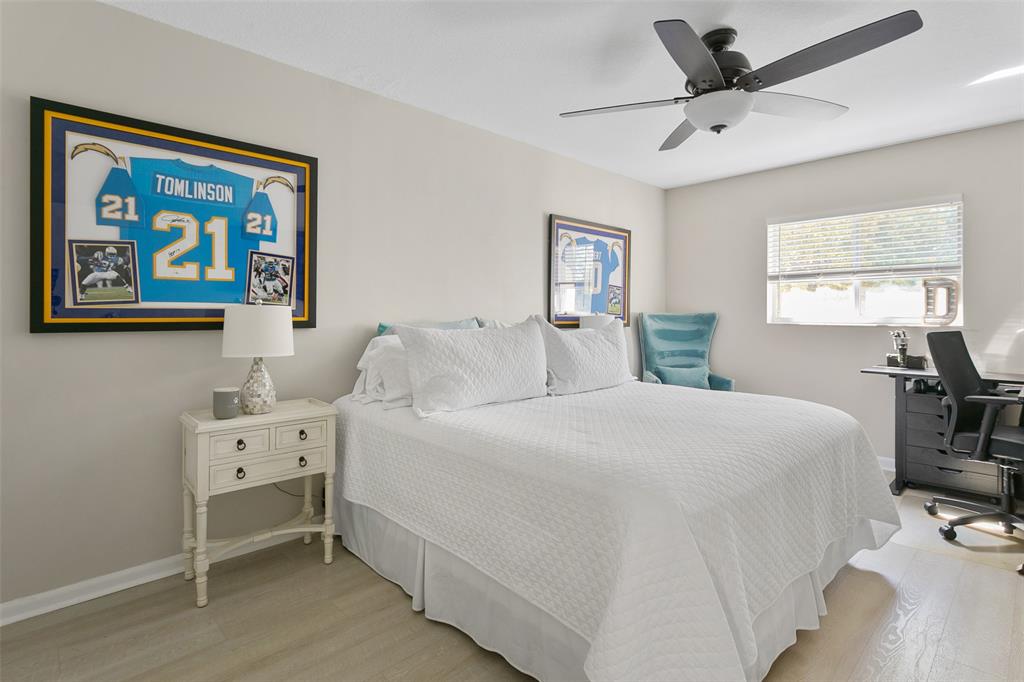 259 South Cypress Road, Unit 546 Pompano Beach, FL 33060 - Photo 17 of 23 a bedroom with a bed and a desk