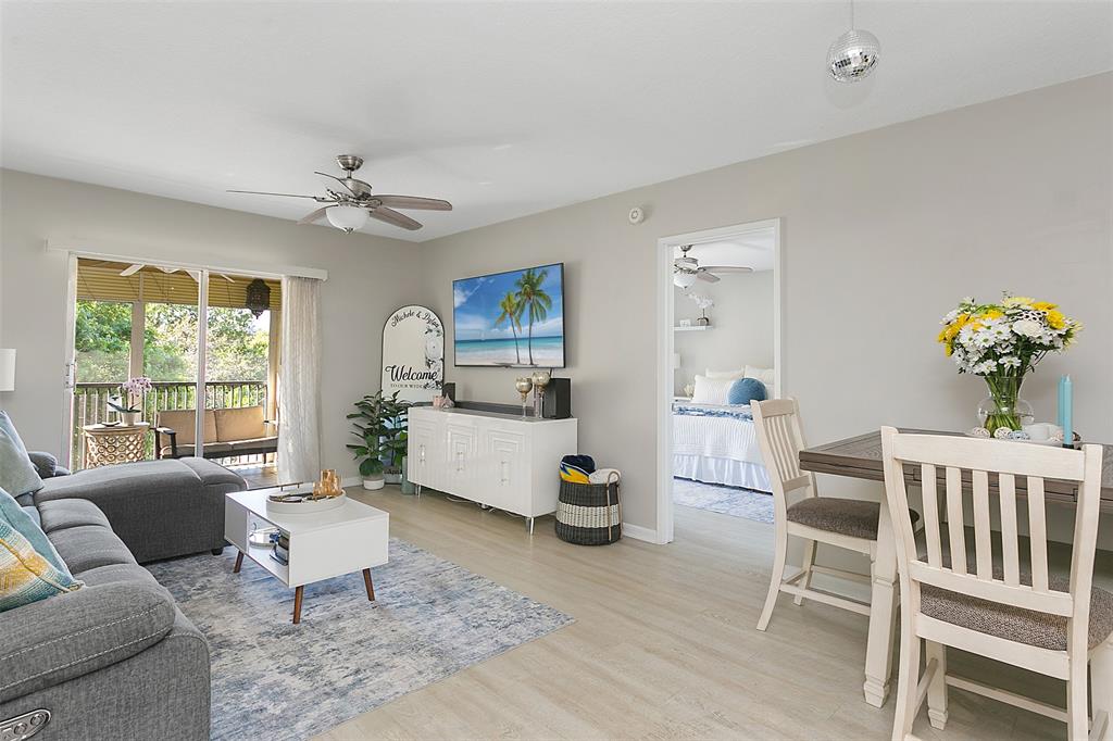 259 South Cypress Road, Unit 546 Pompano Beach, FL 33060 - Photo 4 of 23 a living room with furniture a chandelier and a window