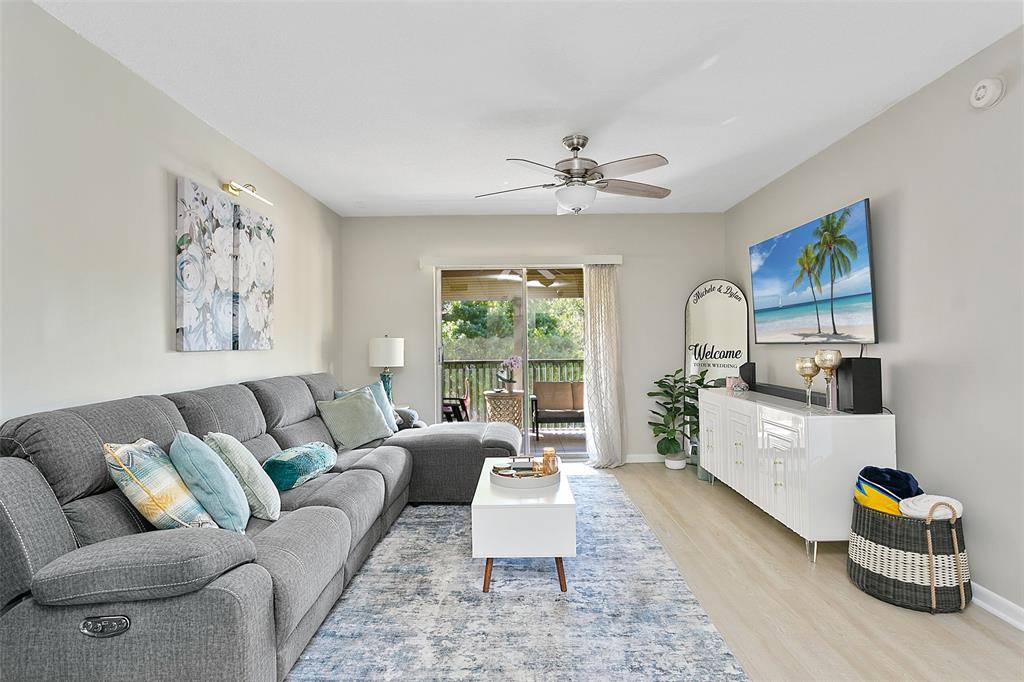 259 South Cypress Road, Unit 546 Pompano Beach, FL 33060 - Photo 6 of 23 a living room with furniture and a large window