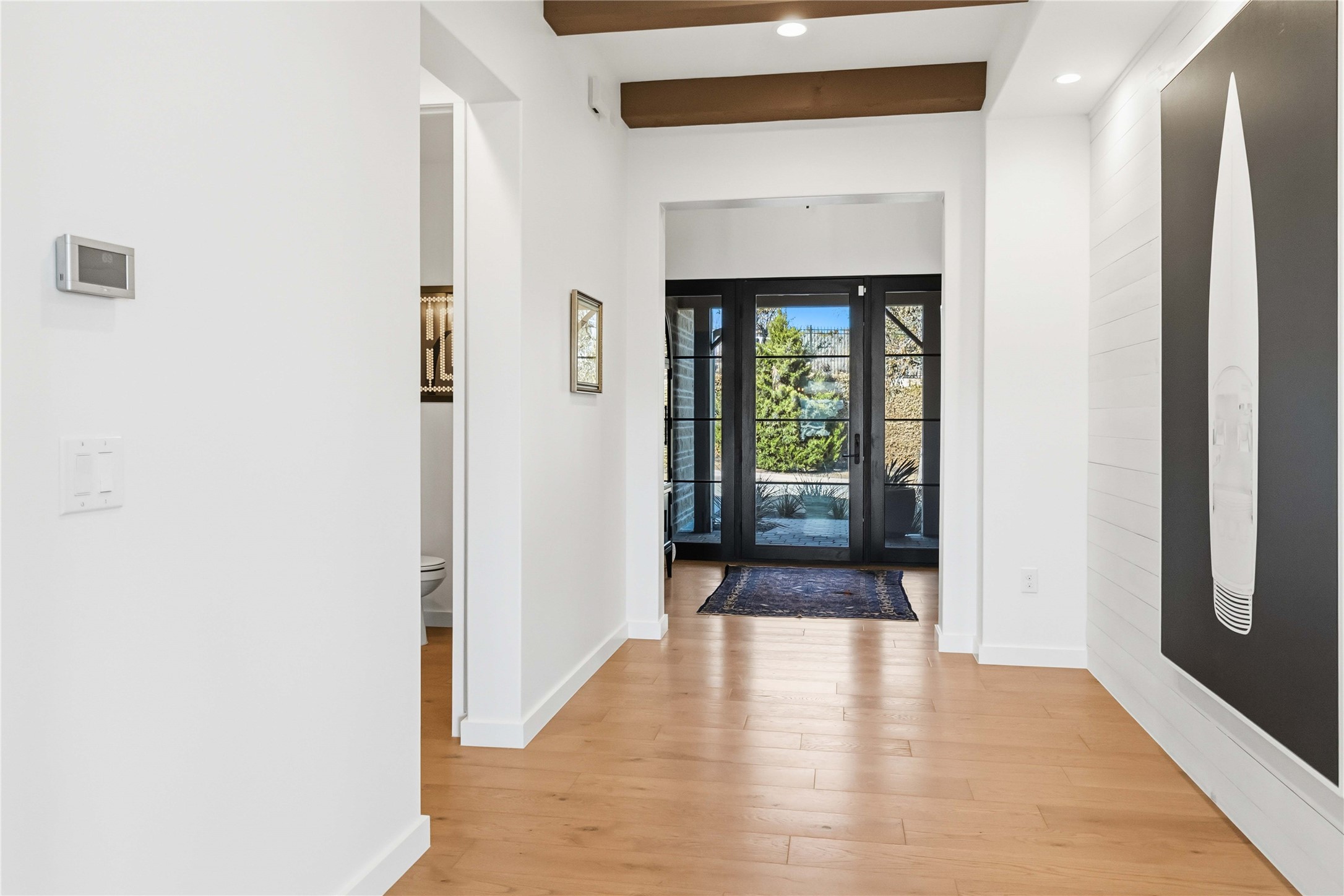 410 Kayak Way Austin, TX 78738 - Photo 4 of 39 a view of a hallway with wooden floor and a bathroom