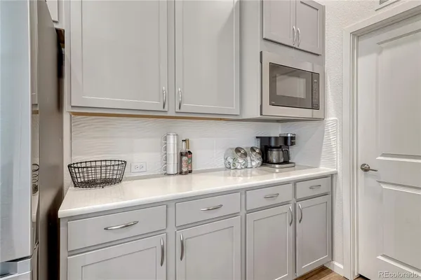 a kitchen with white cabinets and a sink