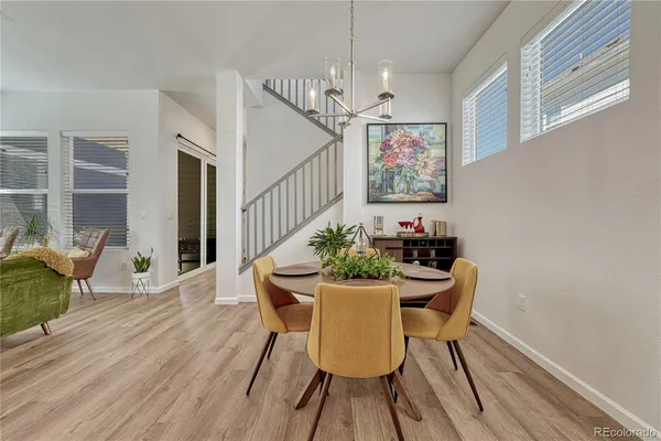 a view of a dining room with furniture wooden floor and a chandelier