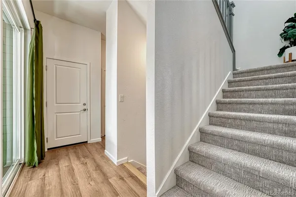 a view of entryway with wooden floor and stairs