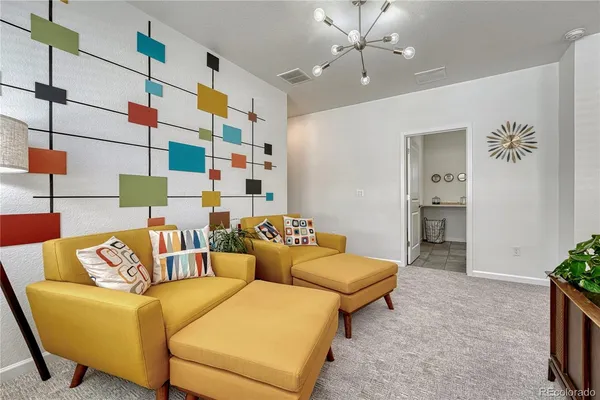 a living room with furniture and a chandelier